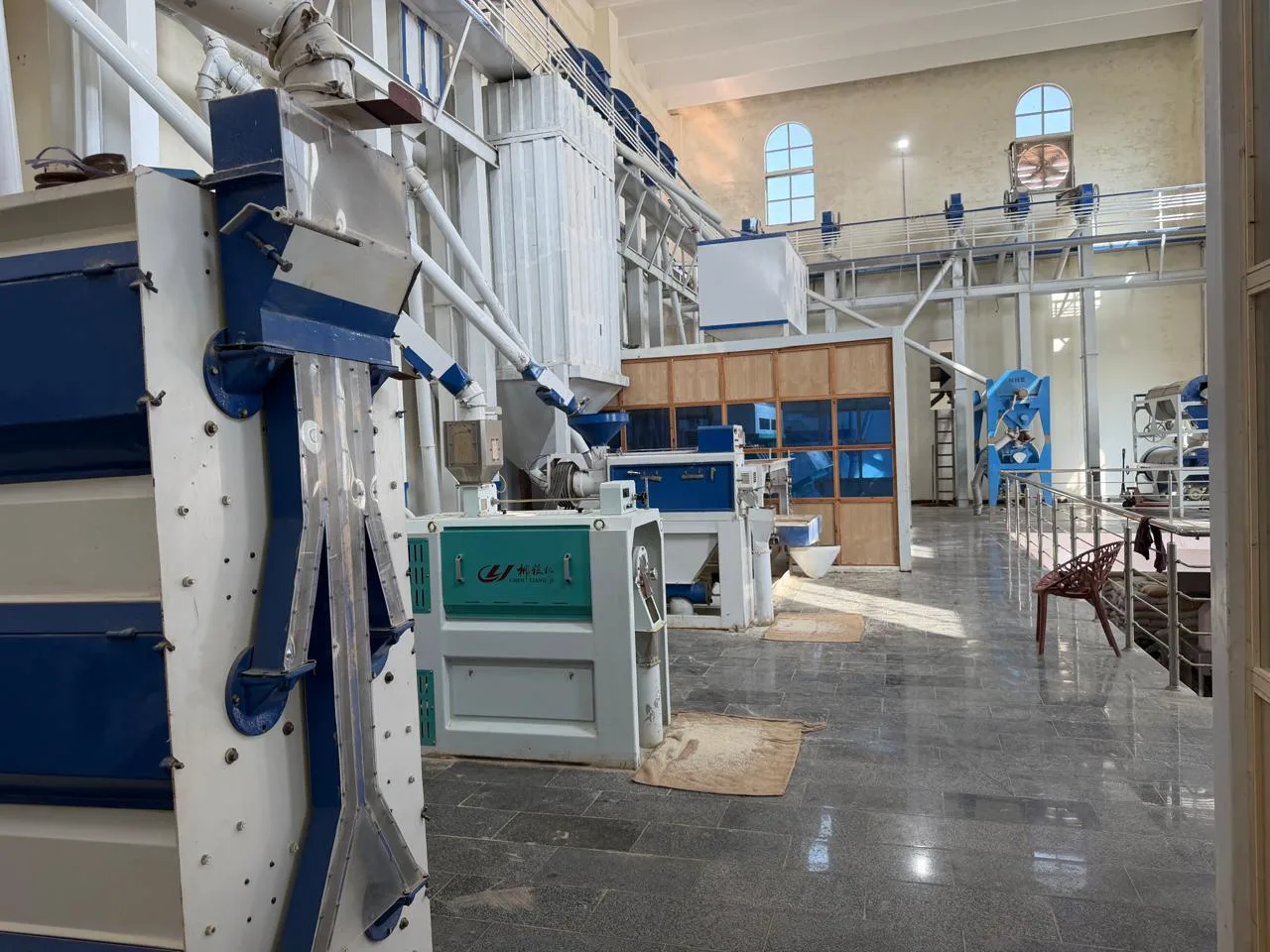 Rows of processing equipment and pipework inside Eagle Rice Mills